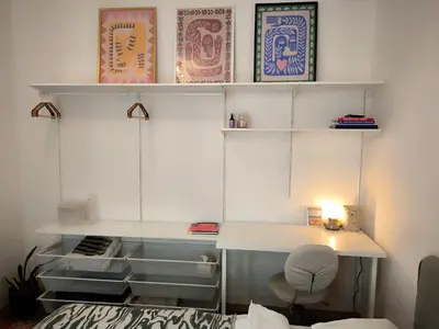 a room with shelves and a desk and a bed at Arty Street Apartment Krymska in Prague