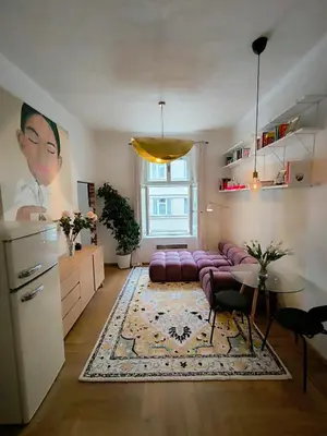 a living room with a purple couch and a table at Arty Street Apartment Krymska in Prague