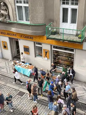 a group of people standing outside of a store at Arty Street Apartment Krymska in Prague