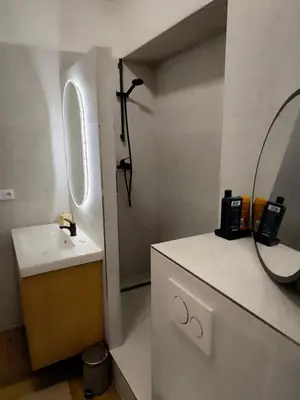 a bathroom with a sink and a mirror at Arty Street Apartment Krymska in Prague