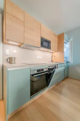 a kitchen with a stove and a microwave at Chic Prague Living at Vista Serenity Apartment with Balcony in Prague