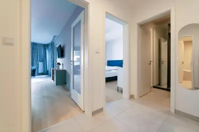 a hallway with a room with a bed and a mirror at Chic Prague Living at Vista Serenity Apartment with Balcony in Prague