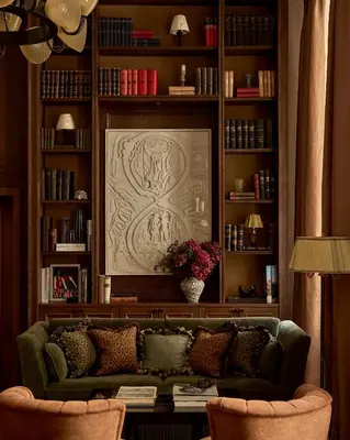 a living room with a green couch and book shelves at Sir Prague, part of Sircle Collection in Prague
