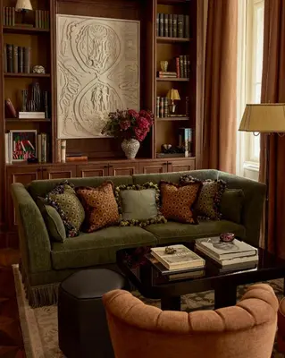 a living room with a green couch and a table at Sir Prague, part of Sircle Collection in Prague