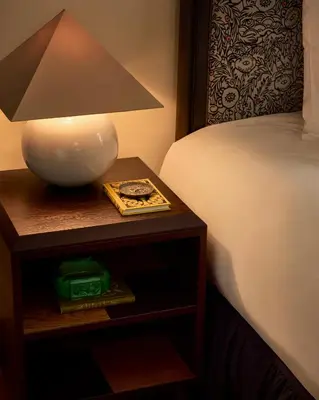 a lamp on a night stand next to a bed at Sir Prague, part of Sircle Collection in Prague