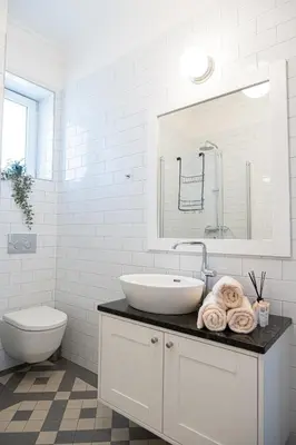 a white bathroom with a sink and a toilet at Rentero Spacious Apartment near Prague Castle in Prague