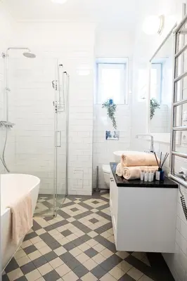 a white bathroom with a tub and a sink at Rentero Spacious Apartment near Prague Castle in Prague