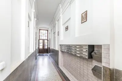 a hallway of a building with white walls at Skyview Haven in Prague