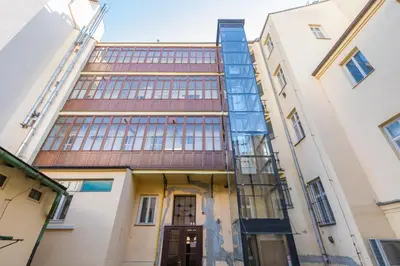 a building with a ladder on the side of it at Skyview Haven in Prague