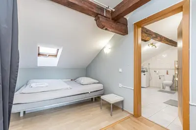 a small bedroom with a bed and a bathroom at Skyview Haven in Prague