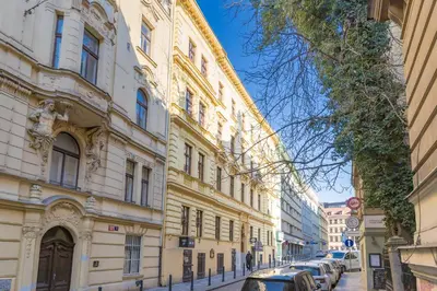 a row of buildings on a street with parked cars at Skyview Haven in Prague