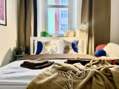 a bedroom with a large bed with a window at Agate Prague Apartment in Prague