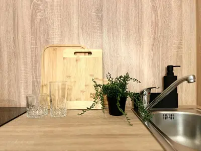 a counter with two glasses and a cutting board at Agate Prague Apartment in Prague