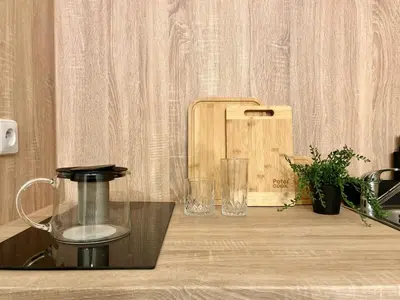 a kitchen counter with a blender and glasses on it at Agate Prague Apartment in Prague
