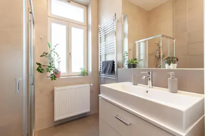 a living room with a table and a couch at Stay Inn Apartments Seifertova in Prague