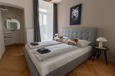a bathroom with a toilet sink and a shower at Stay Inn Apartments Seifertova in Prague