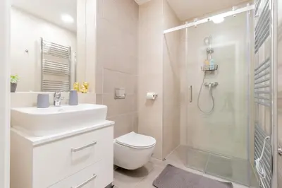 a kitchen and dining room with a table and chairs at Stay Inn Apartments Seifertova in Prague