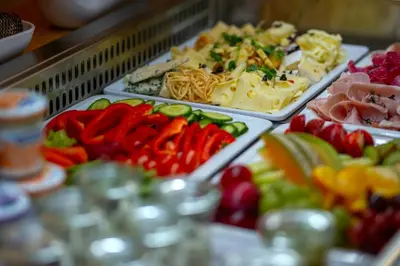 a buffet of different types of food on trays at Hotel NOBILIS - Mladá Boleslav in Bradlec