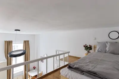 a bedroom with a bed and a balcony at Stay2gether - Vacation at grandma's in Prague
