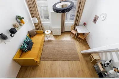 a living room with a couch and a table at Stay2gether - Vacation at grandma's in Prague
