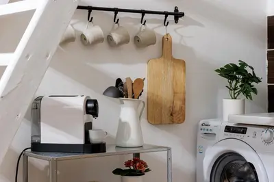 a laundry room with a washing machine and a shelf at Stay2gether - Vacation at grandma's in Prague