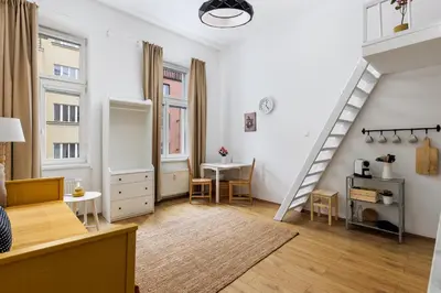 a living room with a staircase and a table at Stay2gether - Vacation at grandma's in Prague