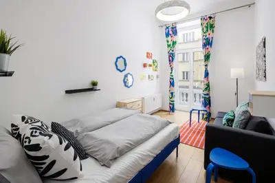 a living room with a bed and a couch at Stay2gether - Grandma's Blues in Prague