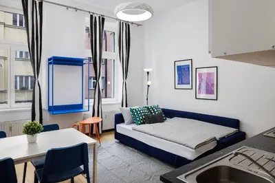 a living room with a couch and a table at Stay2gether - Grandma's Blues in Prague