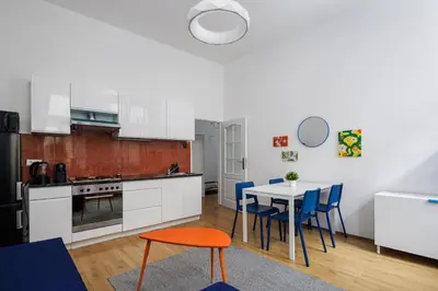 a kitchen and dining room with a table and chairs at Stay2gether - Grandma's Blues in Prague
