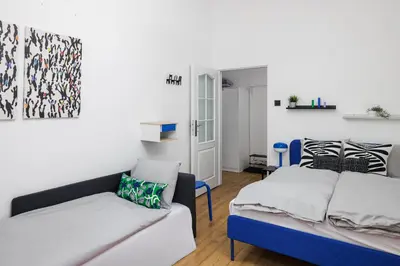 a living room with two beds and a couch at Stay2gether - Grandma's Blues in Prague