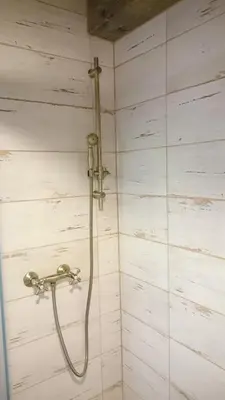 a shower with a hose in a bathroom at Apartmány Vilekula Sázava in Sázava