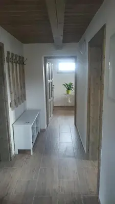 an empty room with a table and a window at Apartmány Vilekula Sázava in Sázava