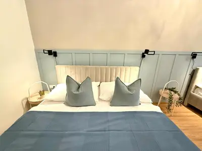 a bedroom with a bed with two pillows at Stunning apartment in middle of Wenceslas Square in Prague