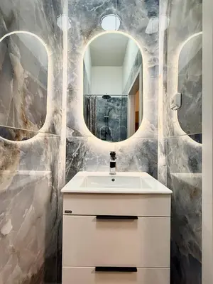 a bathroom with a sink and a mirror at Stunning apartment in middle of Wenceslas Square in Prague
