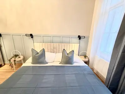 a bedroom with a bed with two pillows on it at Stunning apartment in middle of Wenceslas Square in Prague