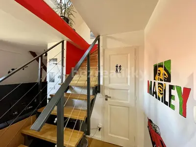 a staircase in a house with a stair case at Podkrovní hnízdečko in Prague