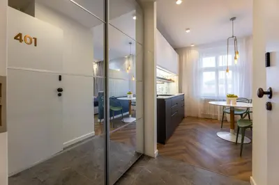 a kitchen with a glass door leading to a dining room at Modern & Stylish Apartments Ječná in Prague