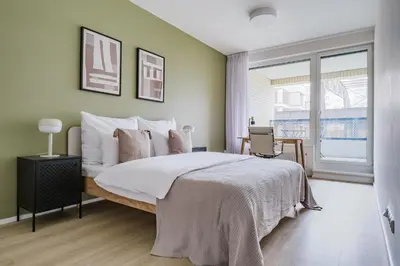 a bedroom with a large bed and a window at Blueground Prague 7 furnished DOX museum PRG-25 in Prague