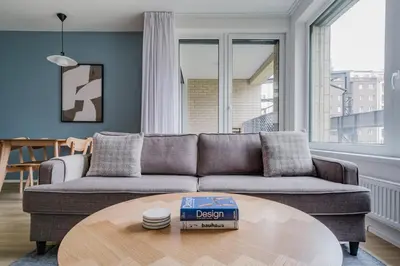 a living room with a couch and a table at Blueground Prague 7 furnished DOX museum PRG-25 in Prague