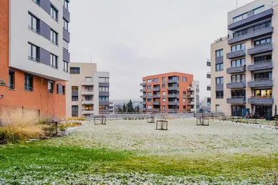 an empty park in the middle of two buildings at Blueground Chodov New build free parking PRG-41 in Prague