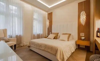 a bedroom with a bed and a chair in it at OLD TOWN LUXURY 3bd APARTMENT in Prague