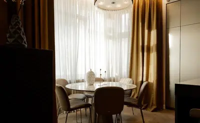 a dining room with a table and chairs and a window at OLD TOWN LUXURY 3bd APARTMENT in Prague