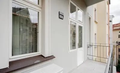 a balcony with white walls and a window at OLD TOWN LUXURY 3bd APARTMENT in Prague