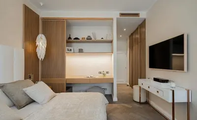 a bedroom with a bed and a desk and a television at OLD TOWN LUXURY 3bd APARTMENT in Prague