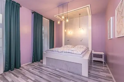 a bedroom with a bed and green curtains at Selin Apartments in Prague