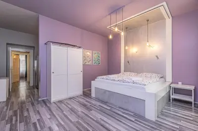 a bedroom with a bed and a mirror at Selin Apartments in Prague