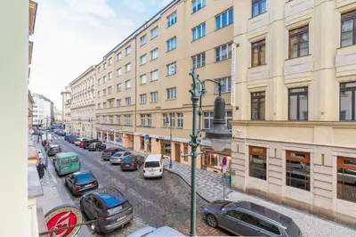 a city street with cars parked in front of buildings at Selin Apartments in Prague