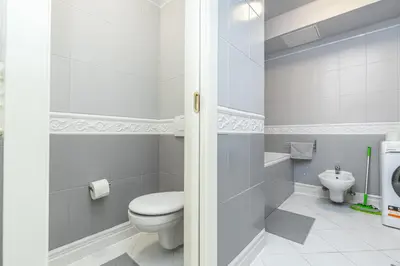 a bathroom with a toilet and a sink at Selin Apartments in Prague