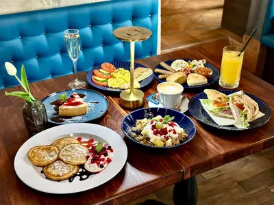 a table with plates of food on top at Studio Melichar Trost in Prague