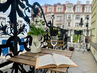a table with an open book and wine glasses at Studio Melichar Trost in Prague